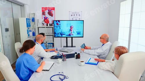 Preview: Group of doctors discussing with expert medic during video conference