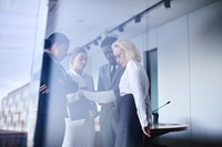 Preview: Four Business People Collaborate at Modern Workplace