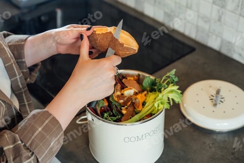 Preview: Compost the kitchen waste, recycling at home. Woman cut leftovers into compost bin