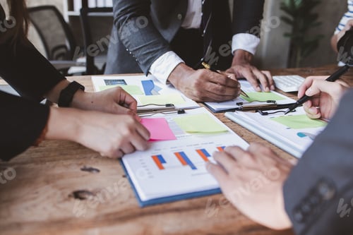 Preview: Group of confident business people point to graphs and charts to analyze market data, balance sheet,