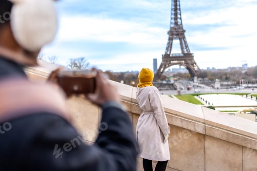 Preview: Couple traveling in paris photographing eiffel tower landmark