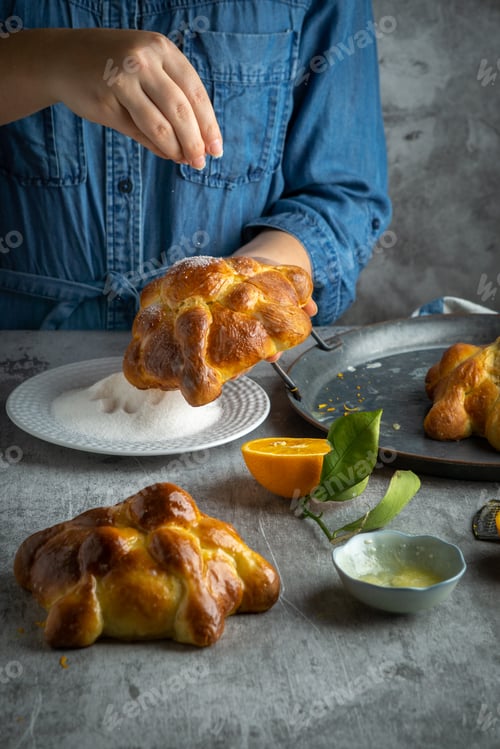 Preview: Woman preparing Pan de muertos bread of the dead for Mexican day of the dead