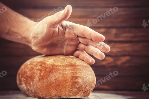 Preview: Baker's hands with a bread.