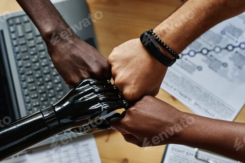 Preview: Above shot of hands of young intercultural coworkers