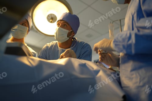 Preview: Surgeons in Masks Performing Operation in Hospital
