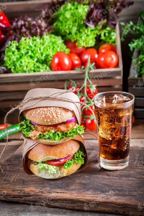 Preview: Takeaway homemade burger with cold drink on old wooden table