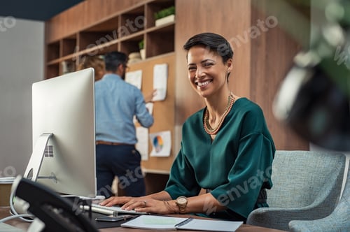 Preview: Young businesswoman smiling at office