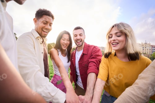 Preview: A group of young business people coming together with a common goal, hands together in solidarity.