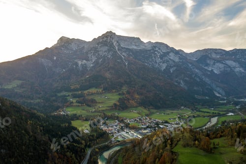 Preview: Aerial view of green meadows with villages and forest in austrian Alps mountains