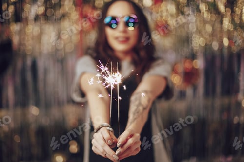 Preview: Woman hands holding sparklers