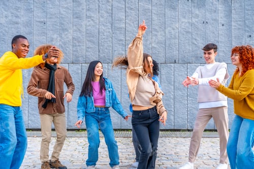 Preview: Woman dancing in the middle of multi-ethnic friends in the street