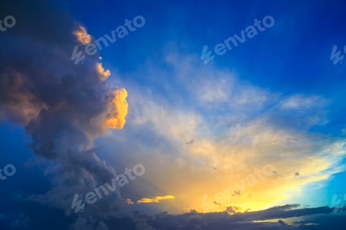 Preview: Dramatic sunset sky with yellow, blue and orange thunderstorm cl