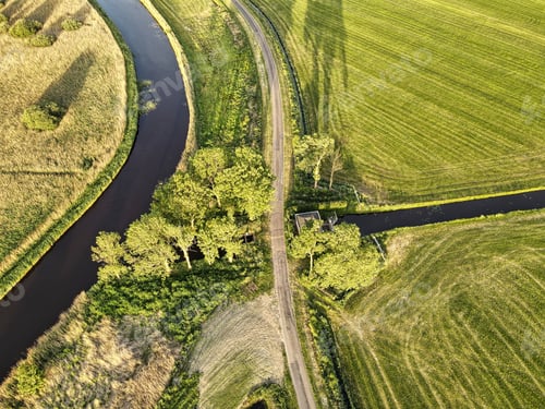 Preview: Birds-eye view shot of a river flowing across the landscape