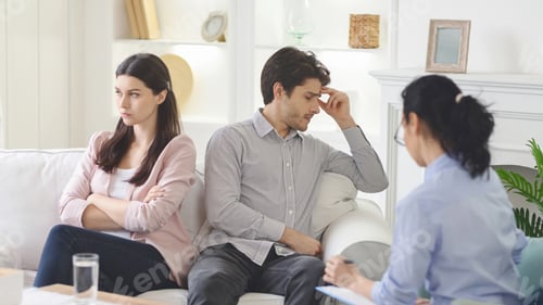 Preview: Frustrated Man and Woman Talking to Therapist on Couch