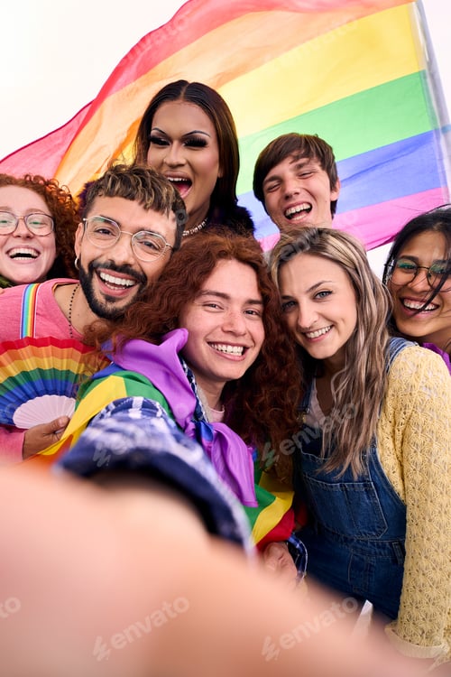 Preview: Group of young diverse LGBT friends taking a selfie looking at front camera of mobile outdoors.