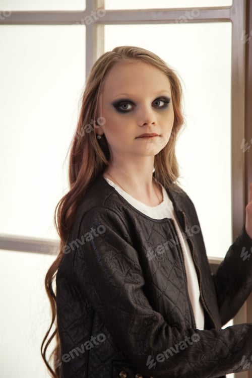 Preview: Portrait of little girl kid 9-10 year old with black stage eyes at large window
