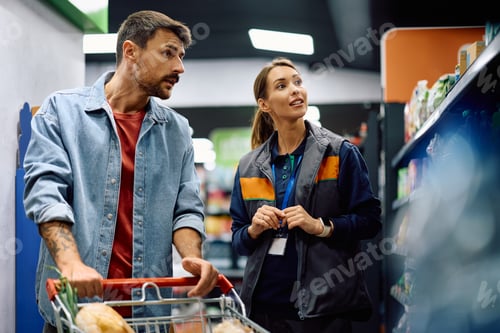 Preview: Female supermarket worker and a customer at the store.