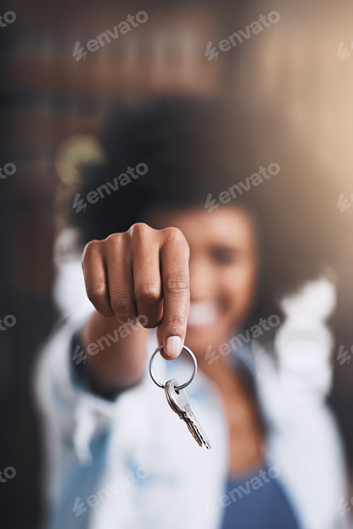 Preview: The keys to freedom. Cropped shot of a young woman holding house keys in her new home.