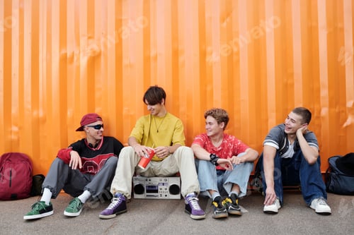 Preview: Teenage Friends Sitting Together Outdoors Talking