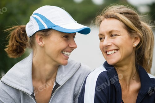 Preview: Two women sharing a joyful moment outdoors