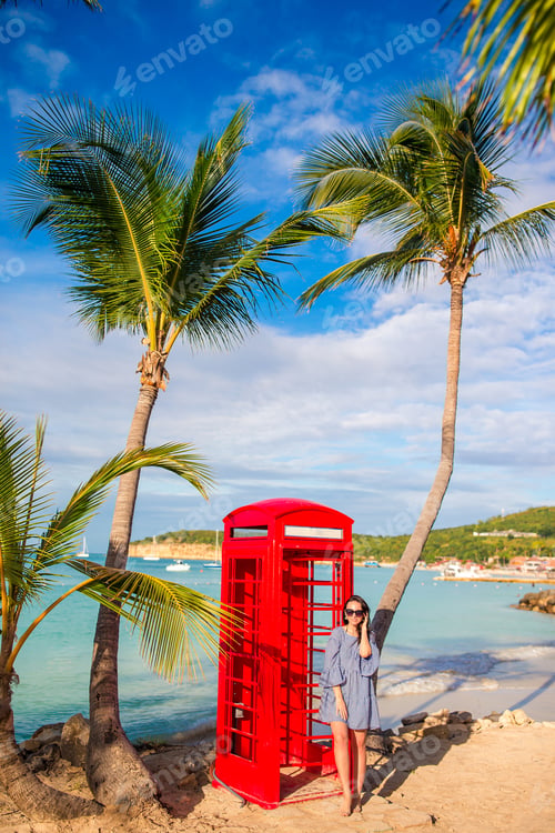 Preview: Beautiftul woman near red phone booth in Dickenson's bay Antigua