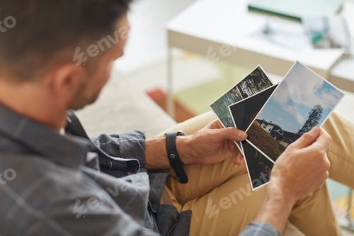 Preview: Man looking at photos