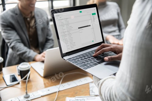 Preview: Man checking his email on a laptop
