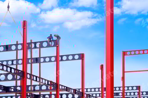 Preview: Construction workers installing castellated beam on red metal poles of factory building structure