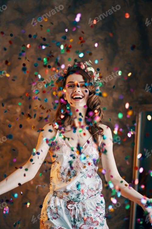 Preview: Happy beautiful woman celebrating with confetti falling everywhere on room
