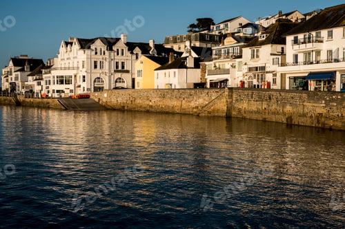 Preview: View along the seawall and facades of houses in Saint Mawes, Cornwall, UK.