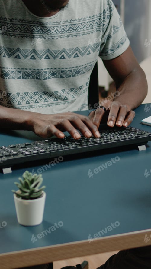 Preview: Close up of african american hands typing on computer keyboard