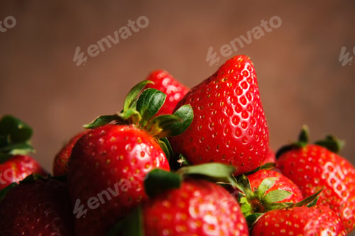 Preview: Strawberries on brown background.