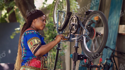Preview: Woman examining modern bicycle in yard