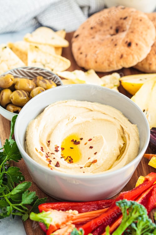 Preview: Hummus bowl with vegetables, fruits, olives, pita and crackers.