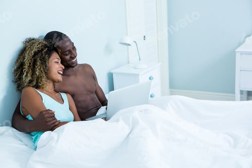 Preview: Young couple using a laptop