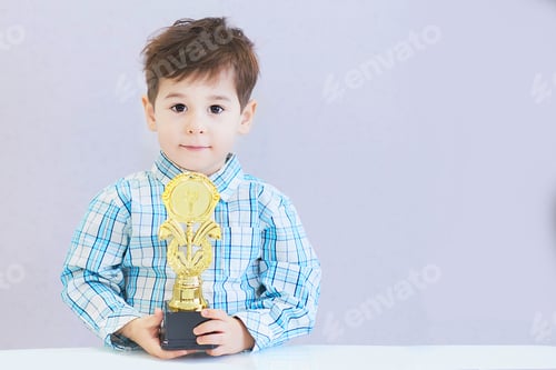 Preview: funny boy age three years old, holding in holding a trophy