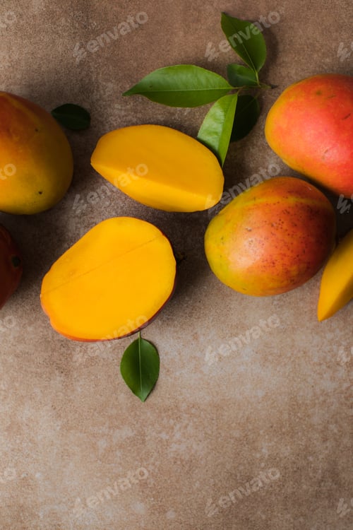 Preview: Mango background design concept. Top view of fresh mango fruit pattern with leaves on table.