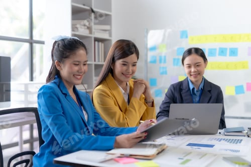Preview: Asian businesswomen collaborate and discuss business plan during team meeting in modern office.