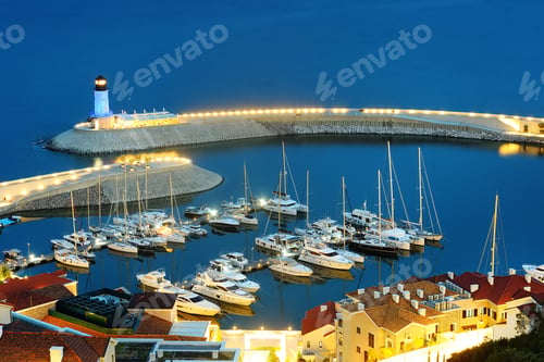Preview: Amazing aerial view with sea, yachts and lighthouse on Lustica bay on blue hour.