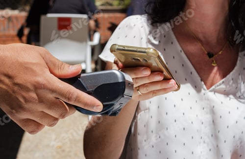 Preview: Woman paying with mobile phone, wireless terminal, payment with mobile
