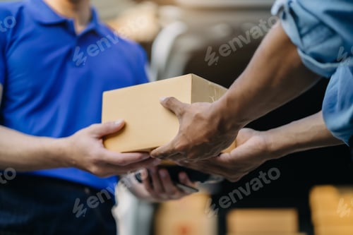 Preview: Male hand accepting delivery of box from delivery man in the morning.