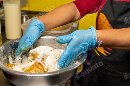 Preview: Cook breading chicken with flour in restaurant kitchen