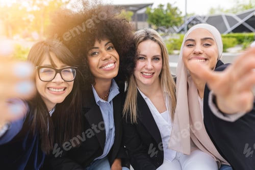 Preview: multiracial female business coworkers making their selfie outdoors