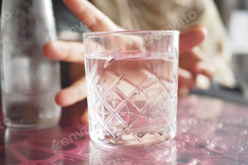 Preview: A Refreshing Glass of Clear Water Placed on a Beautifully Colorful and Artistic Table Design
