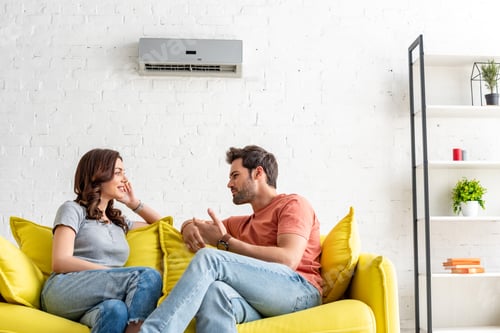 Preview: Happy Couple Relaxing on Couch at Home