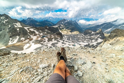 Preview: Trekking Shoes On Feet Of Traveler Hiker Sitting On Top Of The Mountain In The Alps With The