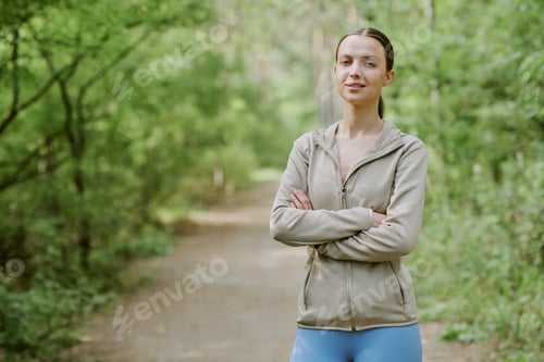 Preview: Portrait of Young Adult Caucasian Woman Standing Confidently Outdoors