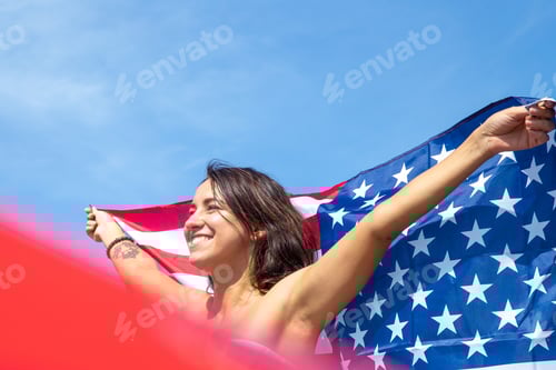 Preview: Smiling Woman Holding American Flag High in the Air