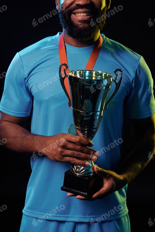 Preview: Sportsman Holding Trophy and Celebrating Victory