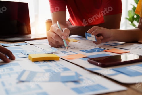 Preview: Group of ux developer and ui designer brainstorming about app interface design at modern office
